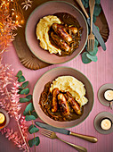 Sausages in an apple wine and mustard gravy on mashed potatoes
