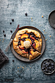 Rustic tart (gallette) with peaches and blueberries, served with vanila ice cream