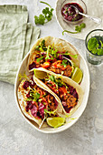 Tacos with beet paste and shredded meat