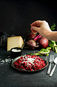 Beetroot risotto with hard cheese, caramelized leaves