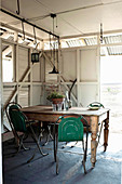 Dining area in summer house made of recycled shutters