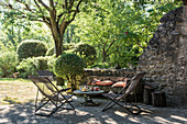 Deckchairs and table on shady terrace