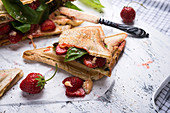 Vegan toasted sandwiches with strawberries, basil and vegan cheese