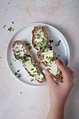 Two slices of sourdough bread with butter and cress