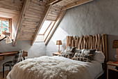 Scandinavian-style double bed with headboard made from branches in guest room