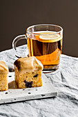 Caramelized chocolate and blueberry mini pound cakes and cup of black tea.