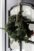 Handmade wreath of fir branches on door