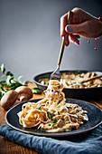 Vegan tagliatelle with a plant-based meat substitute and a creamy mushroom sauce