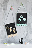 Handmade Halloween flags made from construction paper and googly eyes