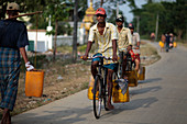 Men carrying water, Myanmar