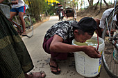 Boy drinking lake water, Myanmar