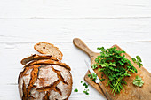 Fresh bread and parsley on a chopping board