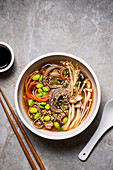 Mushroom and soba noodle soup with beans, carrots, ginger and garlic