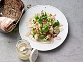 Brussel sprout and cauliflower salad with tomatoes and tahini sauce