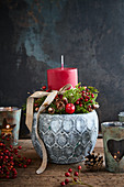 Festive arrangements with red candle in grey flower pot