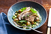 Chicken breast with new potatoes and fava beans in a creamy sauce