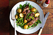 Roasted lamb on a bean salad with new potatoes