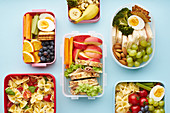 School lunchboxes with various healthy nutritious meals
