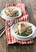 Fried cod on a bed of white beer risotto with peas and asparagus