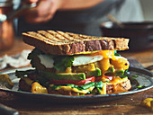 A toasted avocado sandwich with mango chutney