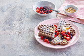 Chocolate waffles with summer berries and flaked almonds