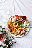 Salad with rice, quinoa, buckwheat, peach, tomatoes and mozzarella