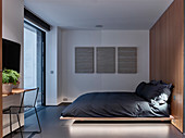 Floating bed in minimalist bedroom