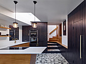 Retro kitchen with black board fronts and patterned floor tiles