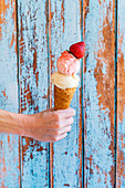 Woman with ice cream cone topped with strawberry fruit powder