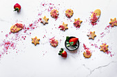 Shortbread biscuits dipped in icing glaze and strawberry fruit powder