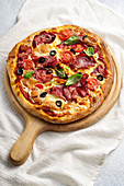 Pizza with prosciutto crudo and olives