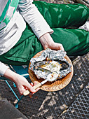 Man eating barbecued banoffee splits