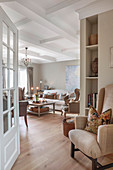 Upholstered furniture and coffered ceiling in living room