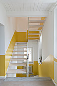 White stairwell with two-tone walls in yellow and white