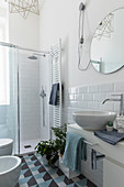 Modern bathroom with subway tiles and graphic pattern on floor