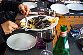 Woman eating mussels in restaurant