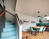 Staircase with pale blue steps in modern, open-plan interior