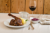 Leg of goose with dumplings and red cabbage