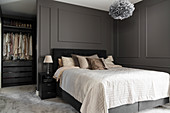 Double bed and walk-in wardrobe in elegant bedroom