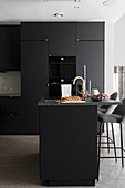 Fitted kitchen with island counter in dark charcoal grey