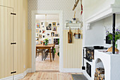 Wood-burning stove in kitchen and view into dining room