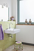 Bathroom with green wall tiles and window
