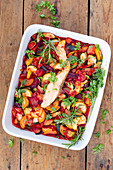 Oven-roasted vegetables with salmon fillet