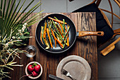 Carrot, asparagus and zucchini sauteed in the pan, on the table ready to eat