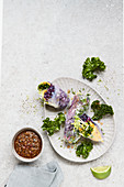 Winter rolls filled with red cabbage and kale with a pumpkin dip