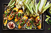 Mexican-style loaded corn cobs with chorizo and chipotle sauce