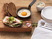 An open ham sandwich and fried egg