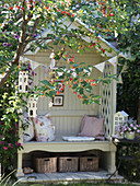Cozy little garden bench with a crabapple tree in the foreground