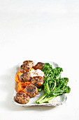 Sweet and spicy beef meatballs with orange mash