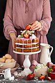 Rustic cake with cream and strawberries
